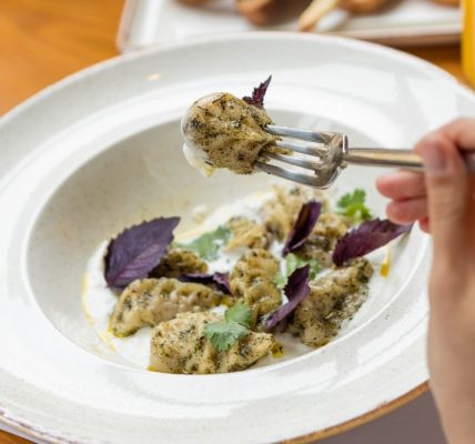 Tasty meat meal, a woman eating with a fork